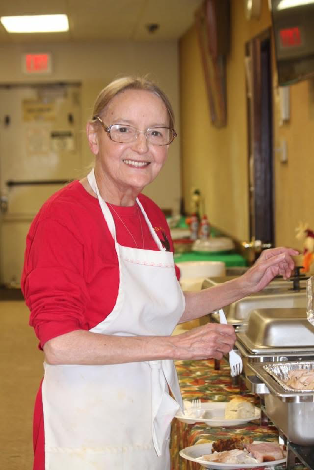 Volunteer serving food at Rosedale Aerie #1100 Monthly Charity Dinner